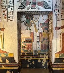 Colorful hieroglyphs and deities in an ancient Egyptian tomb chamber.